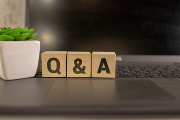 Q and A - short for question and answer. The word q and a arranged from wooden letters