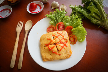nasi goreng pattaya or Pattaya Fried Rice (Stuffed Omelette Fried Rice). Southeast Asian dish made by covering or wrapping chicken fried rice, in thin fried egg or omelette