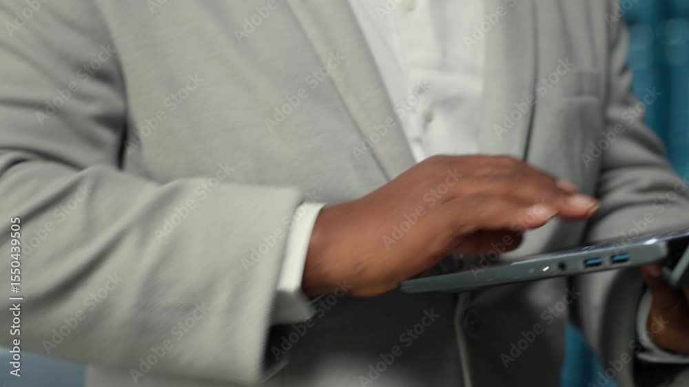 Poster close up of server hub engineer performing maintenance on server racks using software on laptop. dat