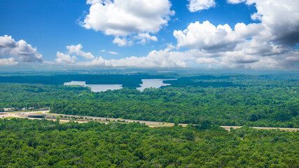 aerial shot of vast miles of lush green trees and homes at the Nashville Superspeedway in Lebanon...