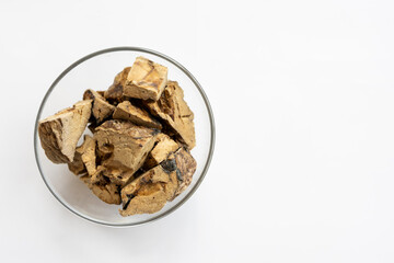 There are different kinds of pet treats in the bowl. Crispy breakfast cereals, chewing gums and pieces of dried meat. For the care of pets and their proper nutrition.