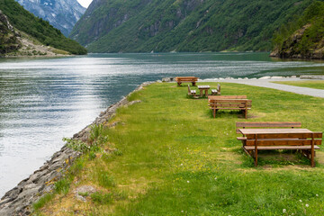 Picnic tables by Naeroyfjord shore in Gudvangen, Norway