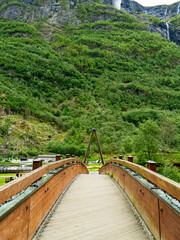 Modern wooden bridge design in a natural Norwegian setting.