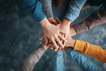 Teamwork with diverse hands stacked showing collaborative spirit