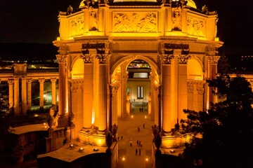 Palace of Fine Arts in San Francisco, USA, illuminated at night. Tourists stroll through the...