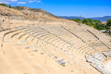 A stone amphitheater with a stone wall surrounding it, amphitheater. Ruins of the ancient city of...