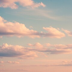 Obraz premium Pastel Pink and Blue Sunset Sky with Fluffy Clouds