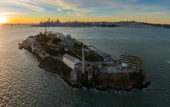 Aerial view of Alcatraz Island, a former prison, now a tourist destination, in San Francisco Bay, California, USA. The city skyline is visible in the background.