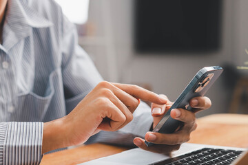 Fototapeta premium Laptop, hands and businessman with cellphone in office for online email communication for corporate review. Technology coffee and hr with computer and phone for reading company policy on internet,