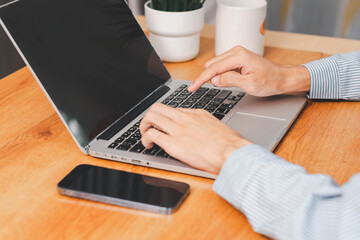 Laptop, hands and businessman with cellphone in office for online email communication for corporate review. Technology coffee and hr with computer and phone for reading company policy on internet,