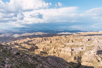 Desertic landscape near gorafe, granada, andalusia, spain, showing erosion and clouds