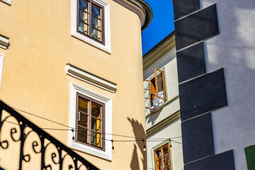 Charming european architecture with sunlit facades and open windows