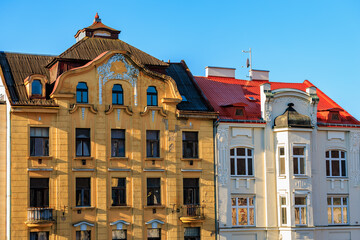 Historic european architecture with ornate facades and red roofs in sunny daylight