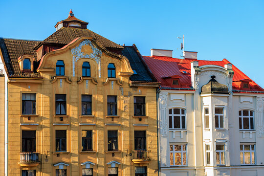 Historic european architecture with ornate facades and red roofs in sunny daylight