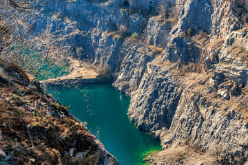 Breathtaking view of pristine lake surrounded by rocky cliffs in serene landscape
