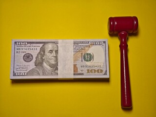 money on the table with judges hammer. money can lead to crime and undo the crime