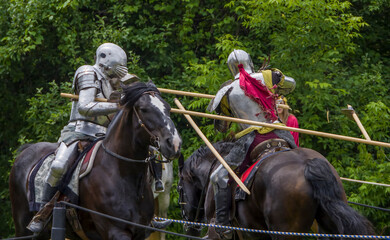 Knights in full armor joust at a bustling medieval faire in Toronto's Black Creek Pioneer Village.