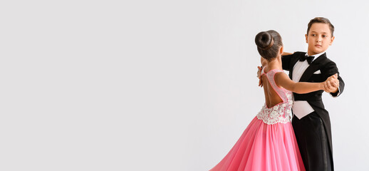 Cute little children dancing against light background