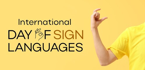 Young deaf mute man on yellow background. Banner for International Day of Sign Languages