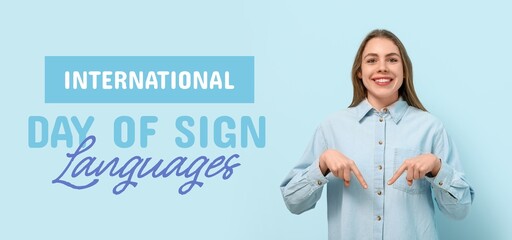 Young deaf mute woman on blue background. Banner for International Day of Sign Languages