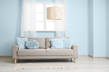 Interior of living room with sofa and light blue elements