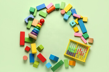 Frame made of different colorful toys on green background. Children's Day celebration
