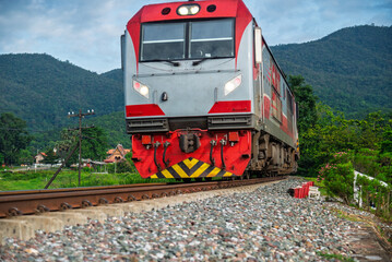 Passenger train by diesel locomotive on the railway.