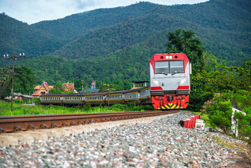 Passenger train by diesel locomotive on the railway.