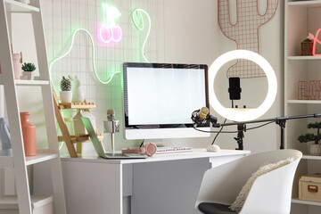 Interior of office with blogger's workplace and shelf units