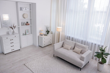 Stylish living room interior. Sofa, dresser, shelving unit and other furniture indoors, above view