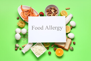 Paper with text FOOD ALLERGY and different products on green background