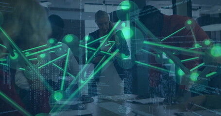 Reviewing team of four professionals analyzing paper documents at modern office, with data overlay