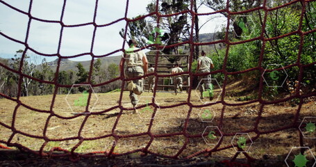 Sprinting four soldiers wearing tan fatigues to obstacle in forest clearing with net HUD icons