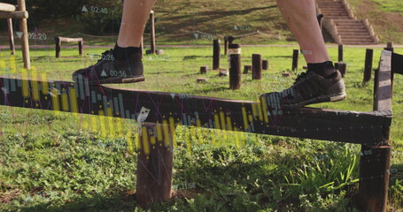 Balancing legs and feet in black athletic shoes on park fitness beam, with digital data overlays