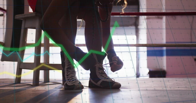 Tying high-top boxing shoe laces, boxer in athletic shorts crouching on ring platform, with graphs - Powered by Adobe