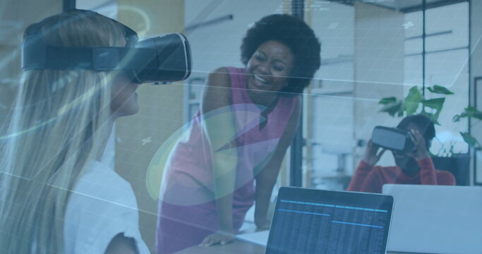 Testing VR headsets by professional women at modern office conference table, showcasing laptop data - Powered by Adobe