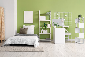 Interior of teenager's room with bed, shelf unit and workplace