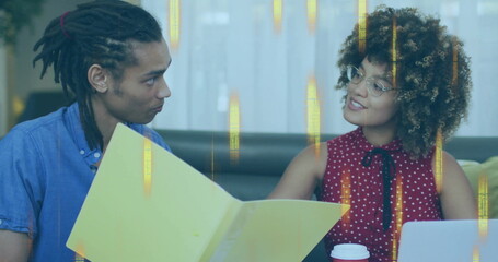 Reviewing document man and woman colleagues consulting in modern office lounge, with yellow folder