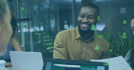 Smiling team lead holding paper stack, collaborating at office table, with notification icons