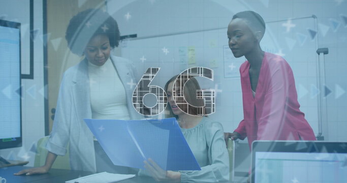 Reviewing three women analyzing documents around conference table, with blue folder, sticky notes - Powered by Adobe