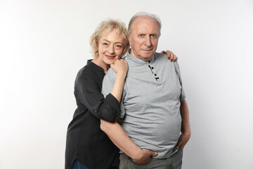 Portrait of lovely senior couple on white background