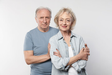 Portrait of lovely senior couple on white background