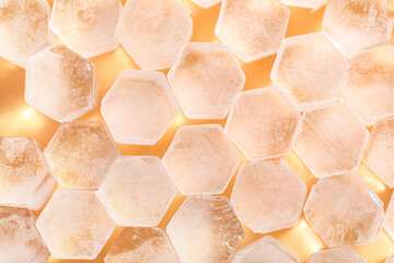 Frozen ice in shape of hexagon on yellow background, closeup