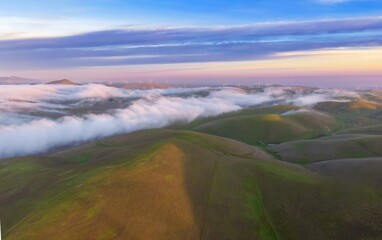 Rolling hills and wind turbines create a scenic landscape in the Livermore, California, USA. The...