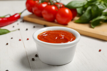 Bowl of tasty ketchup and different ingredients on white wooden background, closeup