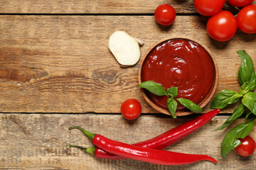 Bowl of tasty ketchup and different ingredients on wooden background