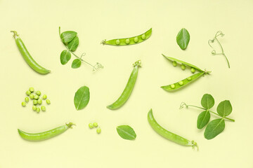 Green pea pods and leaves on color background