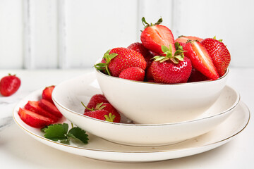 Bowl with fresh ripe strawberries on white background
