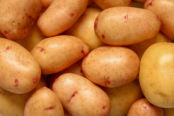 Texture of raw baby potatoes as background