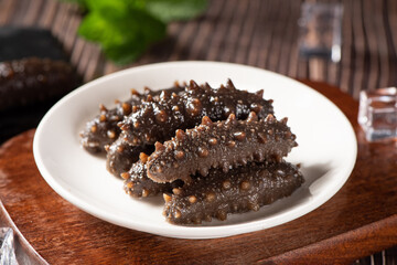 Raw sea cucumber trepang on wooden table.